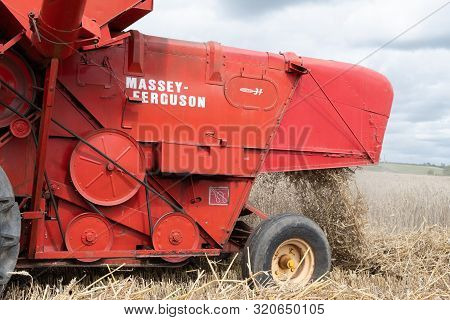 Haselbury Plucknett.somerset.united Kingdom.august 18th 2019.a Vintage Combine Harvester Is Harvesti