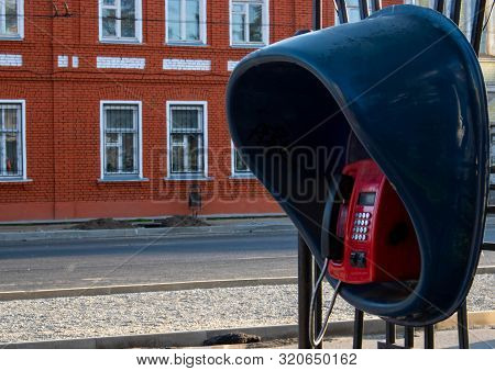 Old And Shabby Outdated Urban Payphone.public Dirty