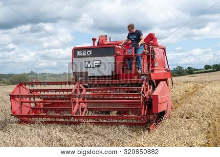 Haselbury Plucknett.somerset.united Kingdom.august 18th 2019.a Vintage Combine Harvester Is Harvesti