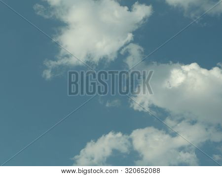 a beautiful blue sky with small white clouds visible.