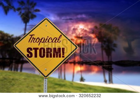Tropical Storm Sign With Dramatic Sky Blured In Background, Dark Sunset An Tornado On The Beach With