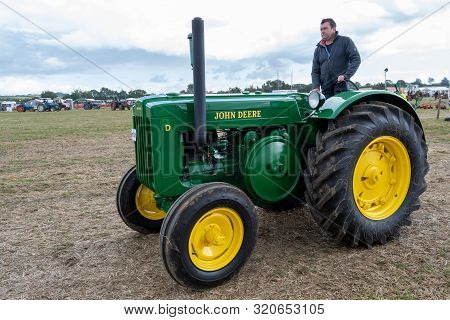 Haselbury Plucknett.somerset.united Kingdom.august 18th 2019.a Vintage John Deere Tractor Is Being D