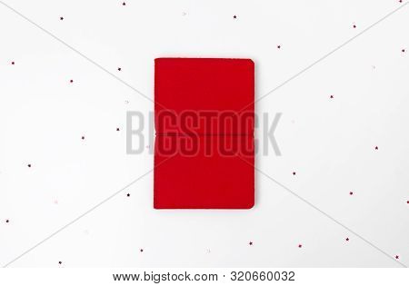 Creative Christmas Monimal Composition With Red Notepad And Star Confetti