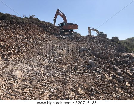 Hydrohammer Is Crushing Rocks During Road Construction Works On The Rocky Soils