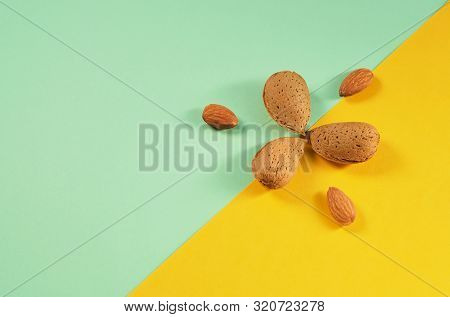 Top View On No Shelled And Shelled Almonds, Kernels On Green Yellow Background. Cute Minimal Modern 