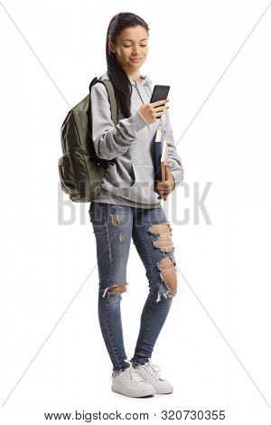 Full length portrait of a trendy young female student with books and mobile phone isolated on white background