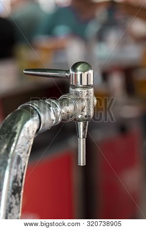 Close-up Of A Cold Chrome-coloured Beer Tap With The Background Out Of Focus.