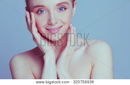 Portrait Of Beautiful Woman With Natural Make Up Touching Her Face.