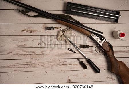 Hunting Equipment. Hunting Rifle, Barrel Cleaning Equipment, Ramrod, Ruff, Oil On A Light Wooden Bac