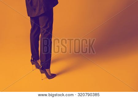Fashionable Women's Pumps And Classic Striped Pantsuit. Young Woman Legs In Black Elegant Shoes.styl