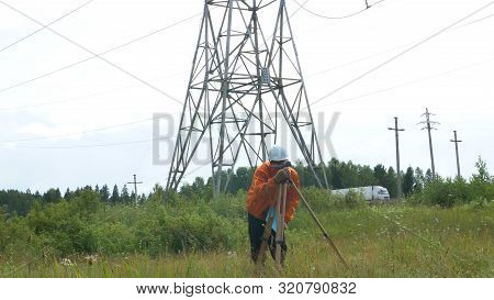 Explorer In Helmet Writes And Looks Through Dumpy Level
