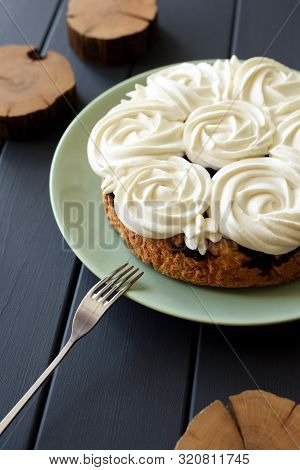 Healthy Dessert. Homemade Cake With Coconut Cream Rose Piping And Small Wood Slabs On Dark Backgroun