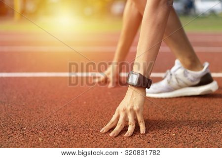 Ready For Running, Cropped Low Angle Of Female Athlete On The Starting Point Of A Running Track With