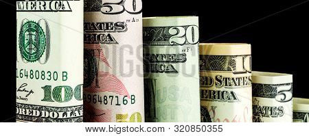 Declining Steps Made Of Blocks Of All American Dollar Denomination Banknotes In One Row On Black Bac