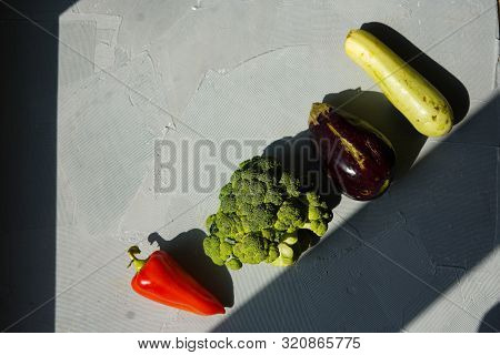 Ugly Vegetables Laid Out In Row On Grey Concrete Background