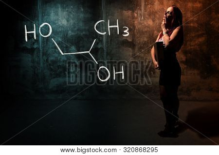 Sexy Girl Or Secretary Or Female Student Presenting Handdrawn Chemical Formula Of Propylene Glycol -