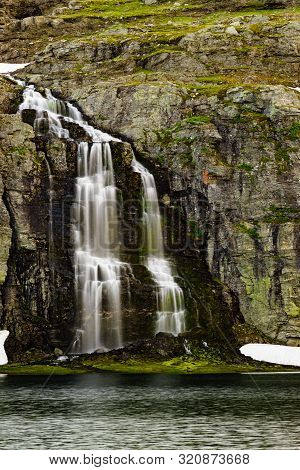 Mountain Lake Flotvatnet With Waterfall. Scenic Region Between Aurland And Laerdal In Norway. Nation