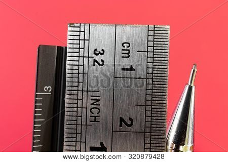 Rulers And Mechanical Pencil Macro Image In Red Background. High Quality Steel Technical Drawing Too