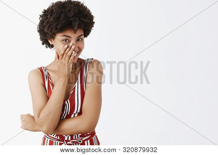 Studio Shot Of Smart And Flirty Attractive Feminine African American In Striped Overalls Chuckling S