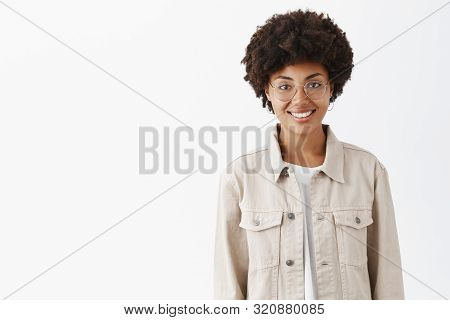 Waist-up Shot Of Friendly-looking Casual Boyish Dark-skinned Woman With Afro Hairstyle In Glasses An