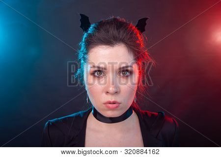 Halloween, Holidays And Carnival Concept - Vamp Woman In Jacket And With Bat Ears In Gothic Style.