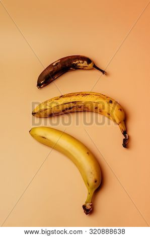 Ugly Fruit Modification Of Three Bananas From Ripe To More Spoiled Brown With Spots Isolated. The Co