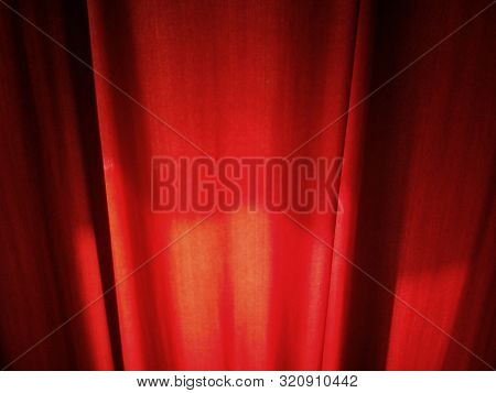 Close-up Of Dark Red Curtains In A Room. Fabric - Dense Velvet, With Daylight Entering The Back Of W