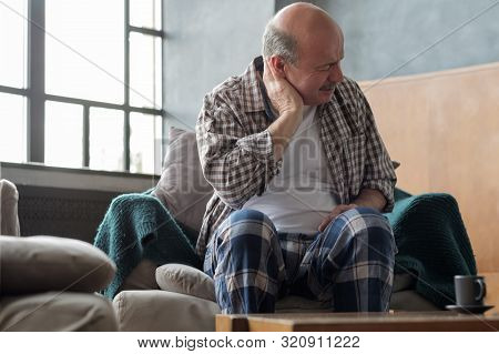 Senior Hispanic Man Is Having Neck Pain Because Of Osteochondrosis.