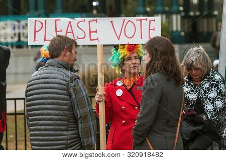 Decatur, Ga / Usa - October 27: A Woman Wearing A Rainbow Wig Holds A Sign Urging People To Vote, At