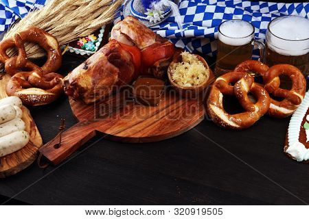 Traditional German Cuisine, Schweinshaxe Roasted Ham Hock. Beer, Pretzels And Various Bavarian Speci