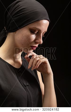 Young Sad Woman With Pimply Skin On Black Background Looking Down, Side View