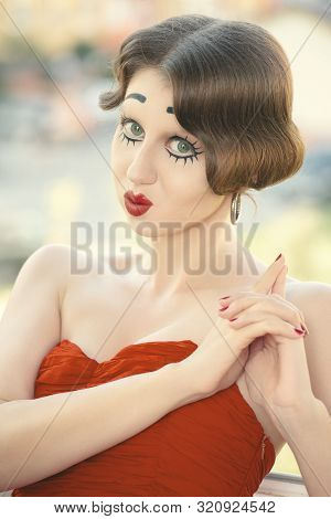 Fun Young Woman With Vintage Pinup Makeup Making Dolly Face Looking At Camera