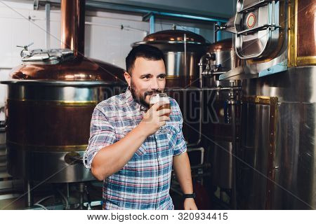 Oktoberfest Festival. Tasting Fresh Brewed Beer. Brewer Holds Glass With Craft Beer. Brewery Concept