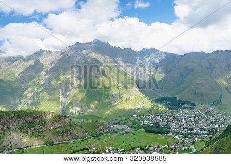 Kazbegi, Georgia - August 2019: Stepantsminda Town View From Montain. Stepantsminda Is The Center Of