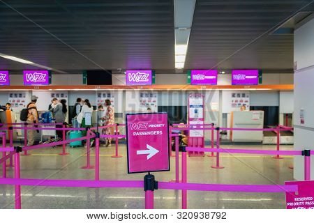 Warsaw, Poland - July 2019: Wizz Air Check-in Counter And Passengers Waiting At Warsaw Chopin Airpor