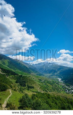 Svaneti Mountain And Village Landscape At The Trekking And Hiking Route Near Mestia Village In Svane