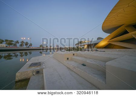 Doha Qatar - July 10 2019; Exterior As Lights Come On National Museum Of Qatar Unusual But Striking 