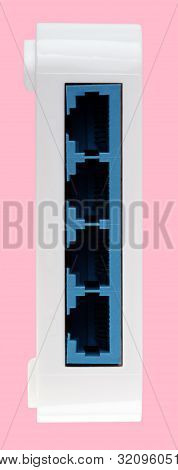 White 8 Port Plastic Ethernet Switch Isolated On Pink Background At Dry Day