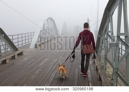 Umea, Sweden - August 24, 2019: A Young Man Is Out Resting His Dog In The Fog Over The Old Bicycle B