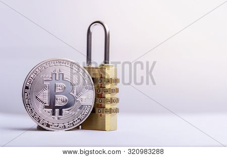 Bitcoin(btc) Coin With Padlock Lying On White Background.
Bitcoin Security. Digital Cyber Safety Or 
