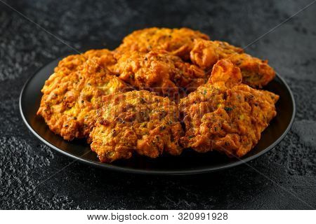 Indian Takeaway Food, Spicy Onion Bhajis On Black Plate