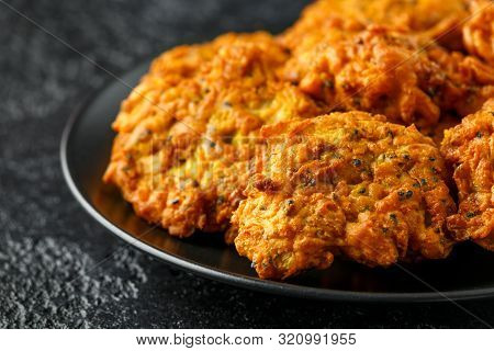 Indian Takeaway Food, Spicy Onion Bhajis On Black Plate