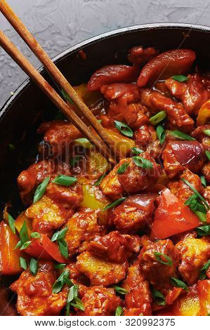 Chicken Manchurian In Pan At Black Concrete Background. Chicken Manchurian Is Indian Chinese Cuisine