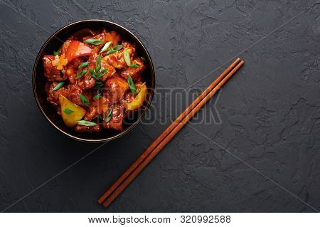Chicken Manchurian In Pan At Black Concrete Background. Chicken Manchurian Is Indian Chinese Cuisine
