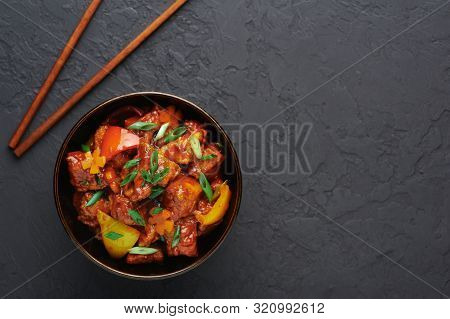 Chicken Manchurian In Pan At Black Concrete Background. Chicken Manchurian Is Indian Chinese Cuisine