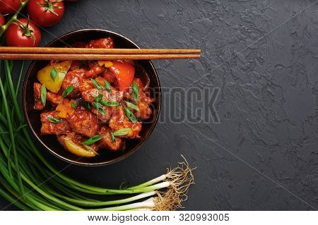 Chicken Manchurian In Pan At Black Concrete Background. Chicken Manchurian Is Indian Chinese Cuisine