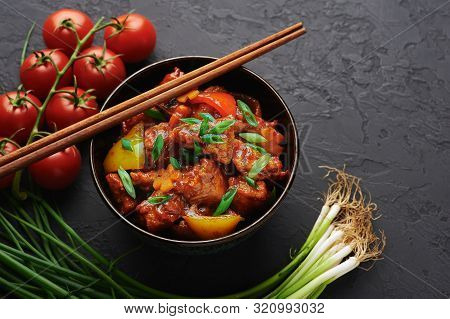 Chicken Manchurian In Pan At Black Concrete Background. Chicken Manchurian Is Indian Chinese Cuisine