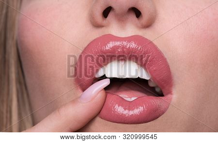 Open Female Mouth With Pink Lipstick. White Teeth Of Beautiful Young Women. Seductive Lady Mouth And
