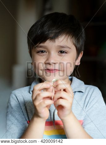 Portrait Happy Kid Looking At Camera With Smiling Face, Adorable Child Playing Alone  In Living Room