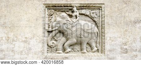 Grunge background with stone texture and bas-relief with elephant rider. Horizontal banner with ancient ornament. Copy space for text. Mock up template